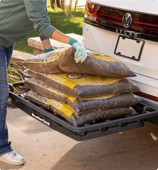 HitchBasket being loaded with bags of mulch